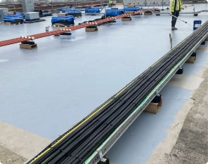 Industrial roofing membrane installation with safety railing and equipment