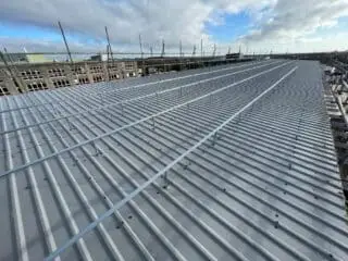 Twin skin metal roof cladding