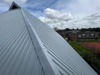 steep pitch metal clad roof profile system including skylight