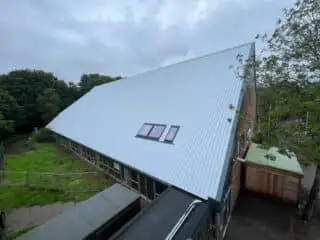 steep pitch metal clad roof profile system including skylight