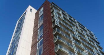 View of large residential building showing various facade systems