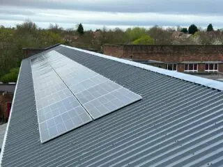 Large metal roof with flush solar pv panel system