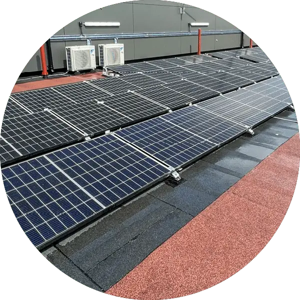 Circular crop of solar panels installed on a flat roof with red walkway mats alongside