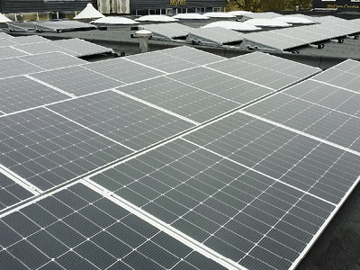 Rows of solar panels covering a flat roof area