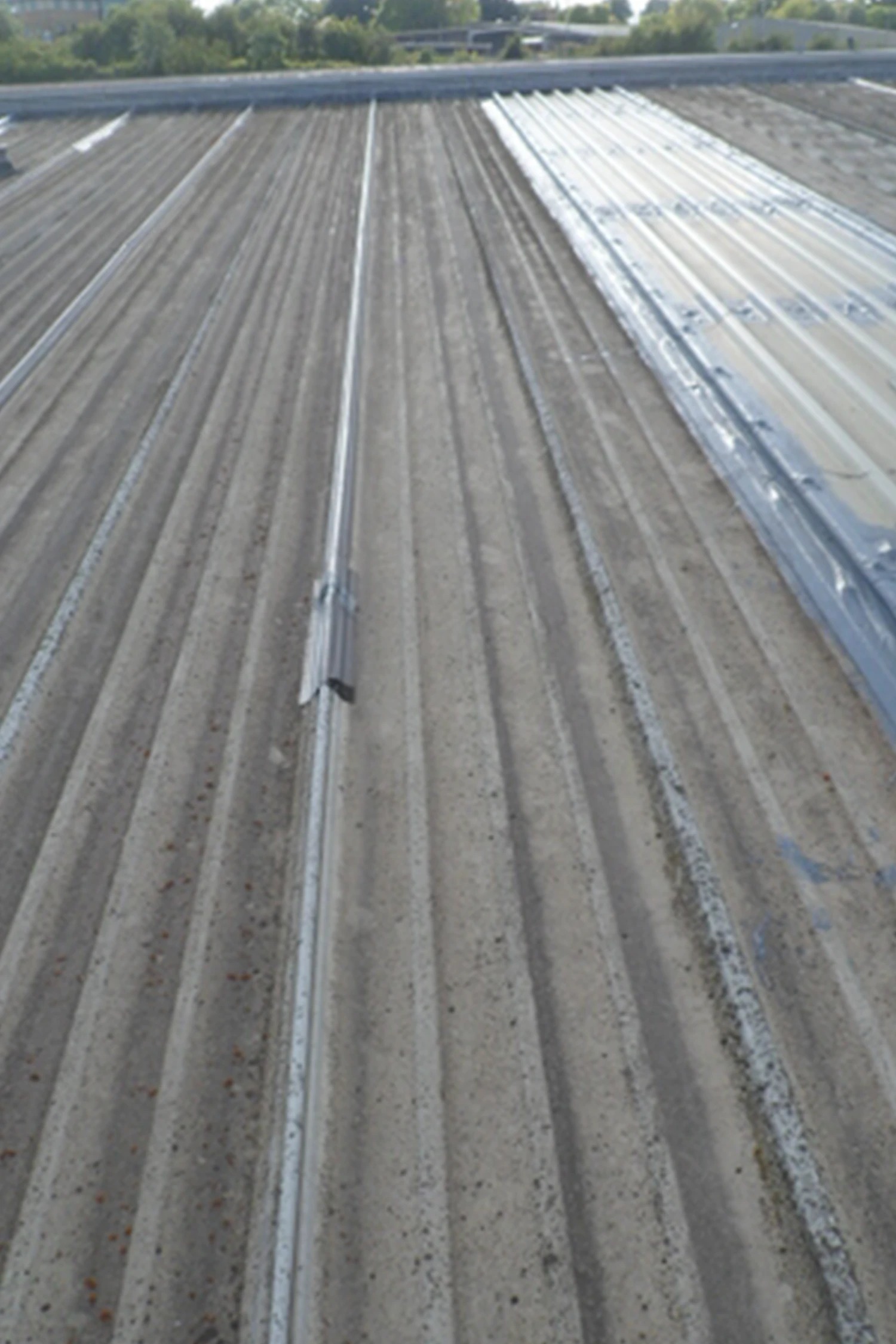 Standing seam metal roof with weathered surface and visible seams