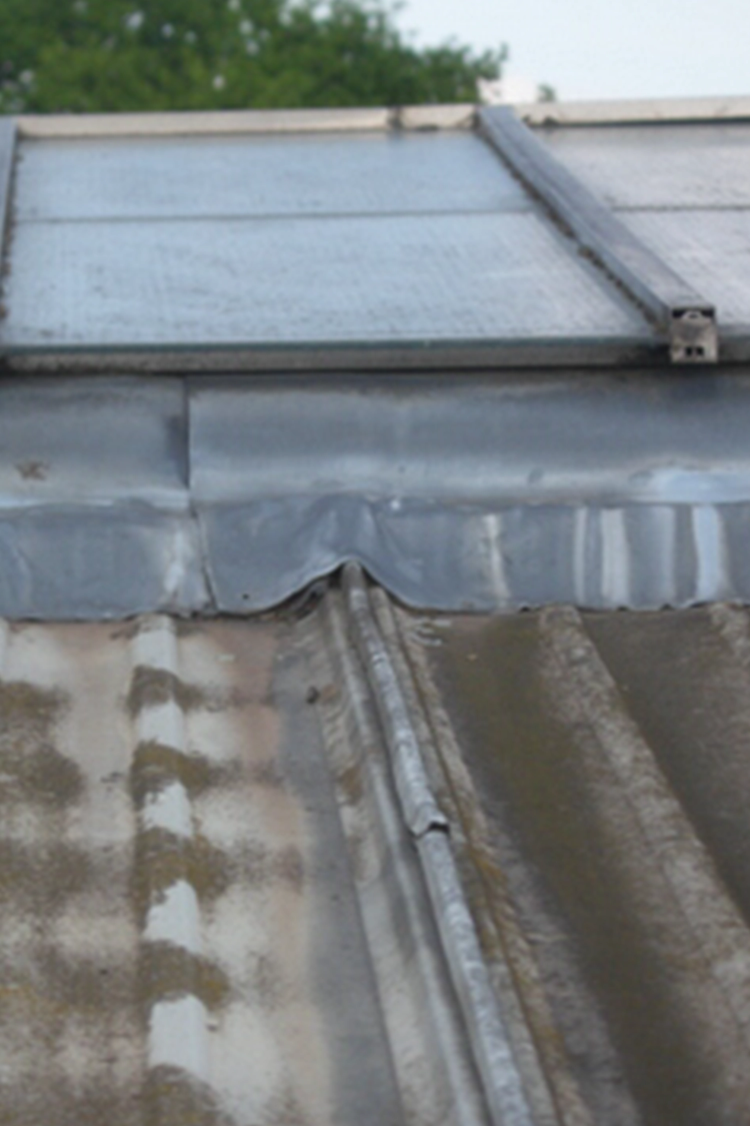 Standing seam metal roof with protective covering and guttering system installed
