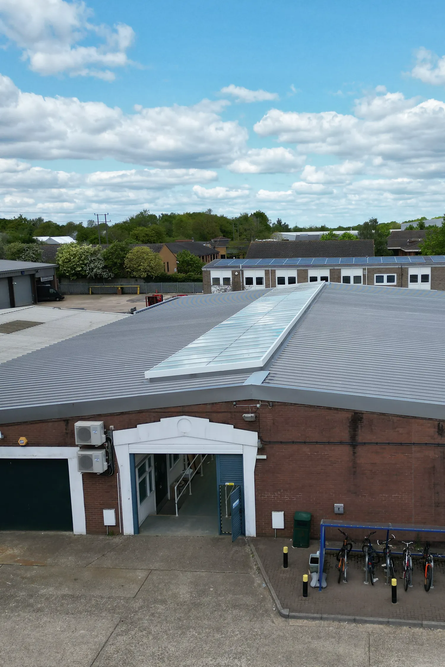 Modern industrial building with standing seam metal roof and solar panels