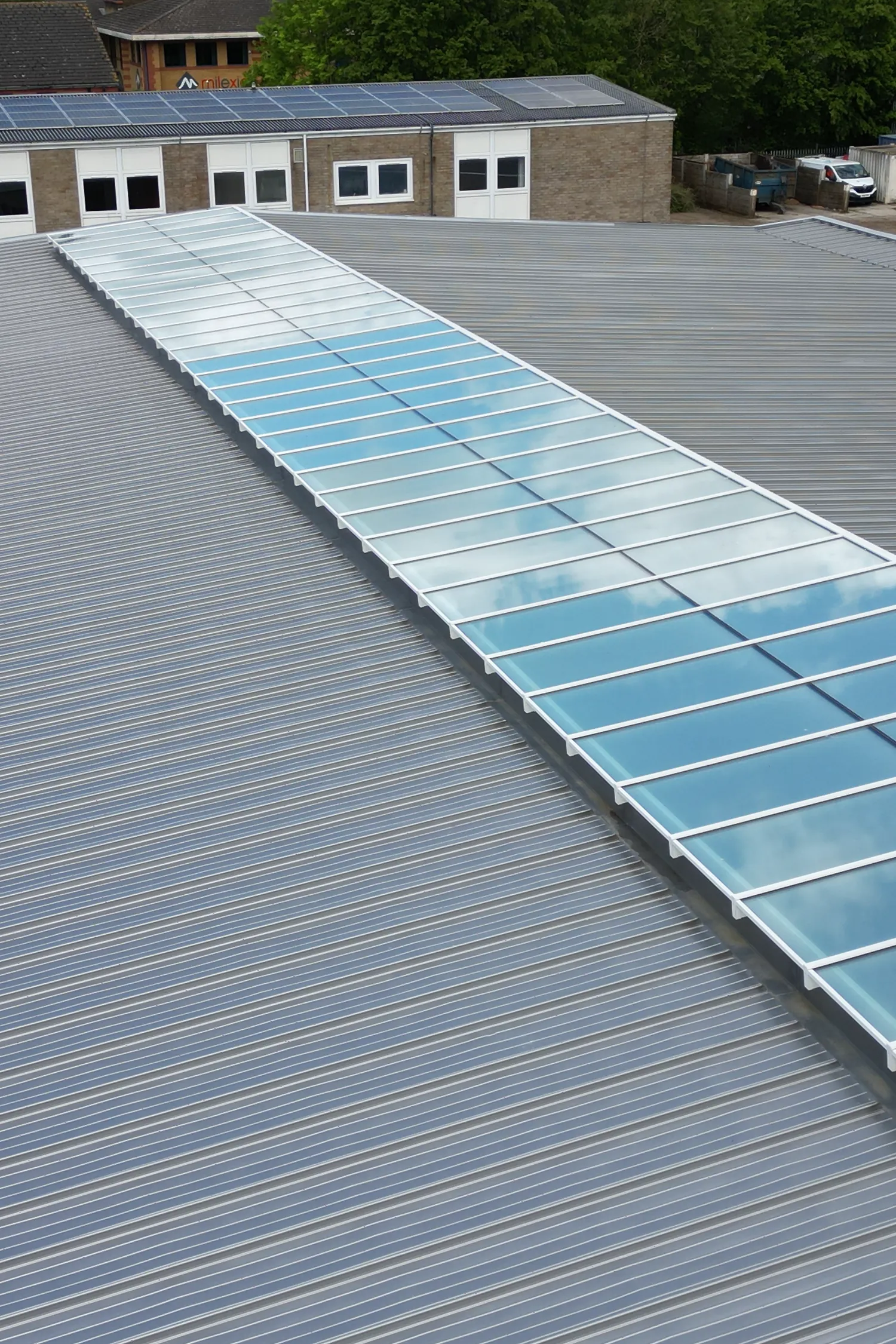 Standing seam metal roof with solar panels installation on commercial building
