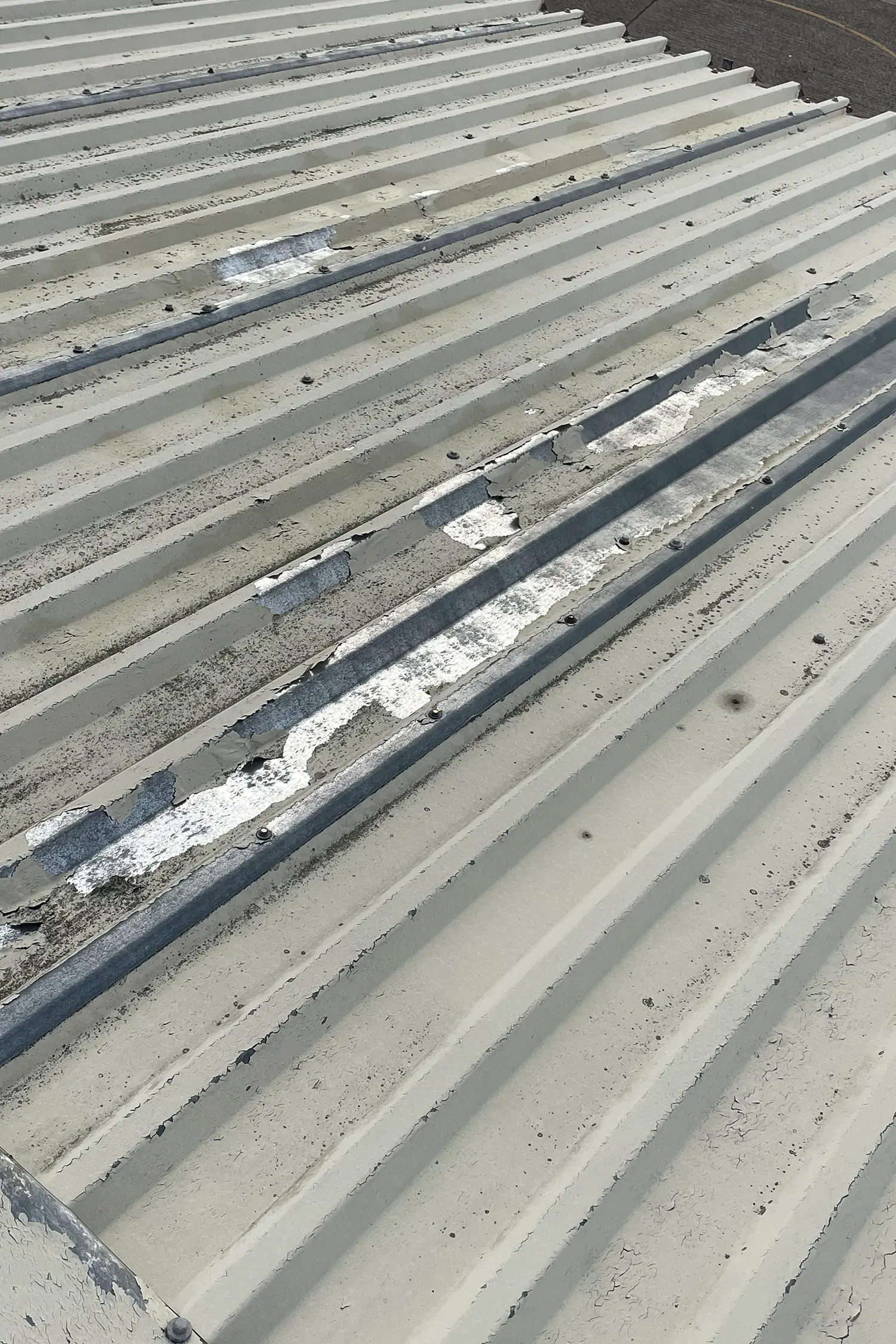 Concrete roof deck with metal flashing and fasteners during solar installation preparation
