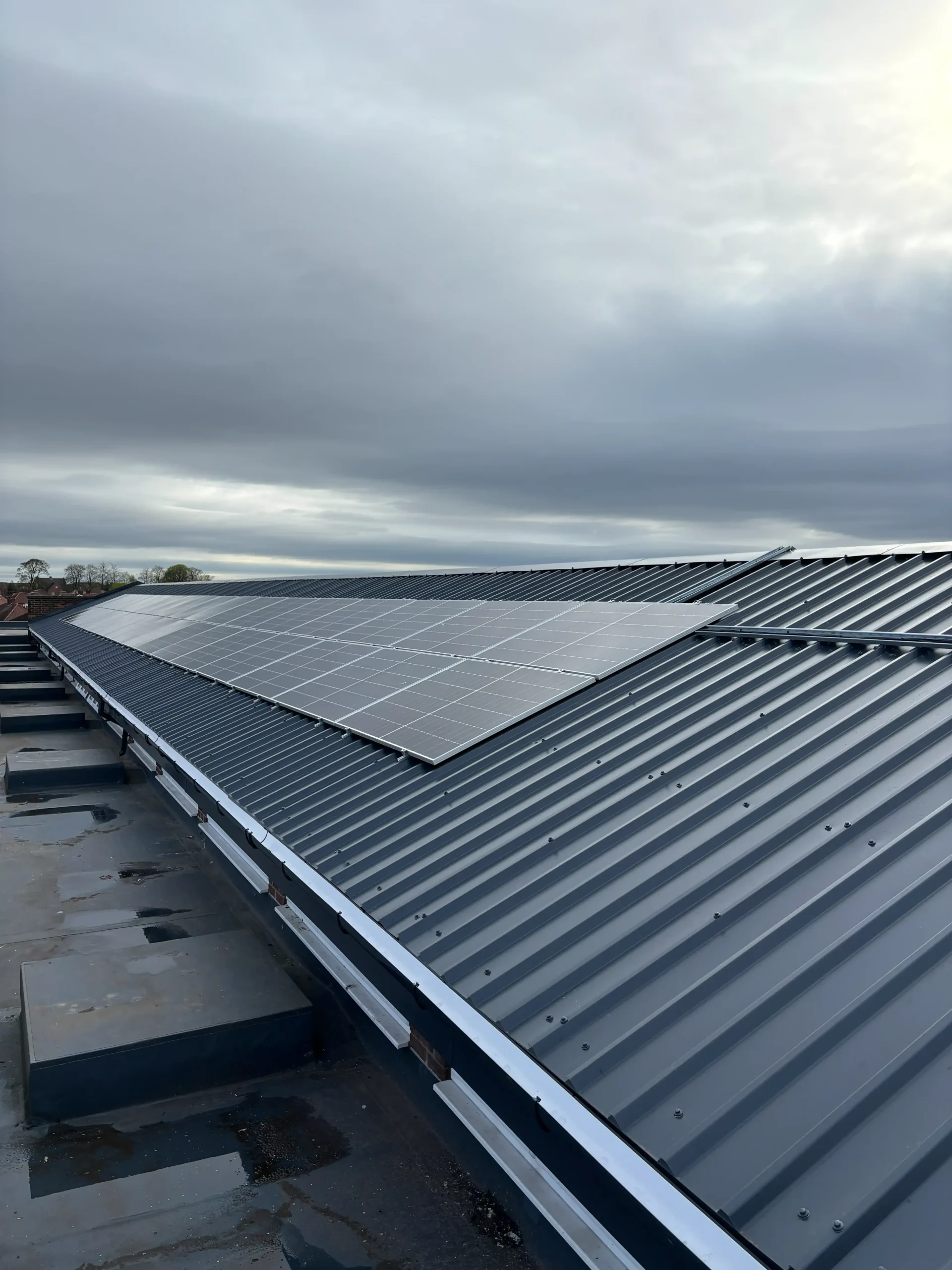 Solar panel array installed on industrial metal roof structure