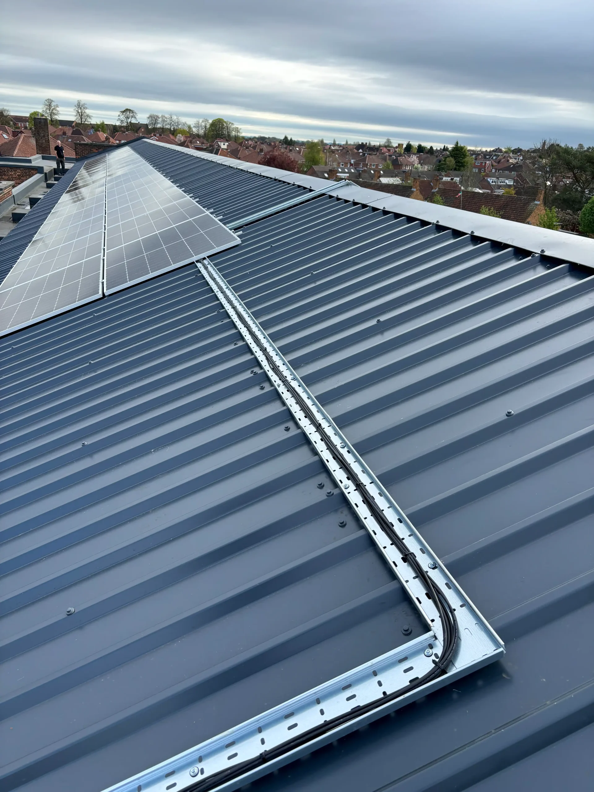 Solar panel installation on school building roof with metal framework
