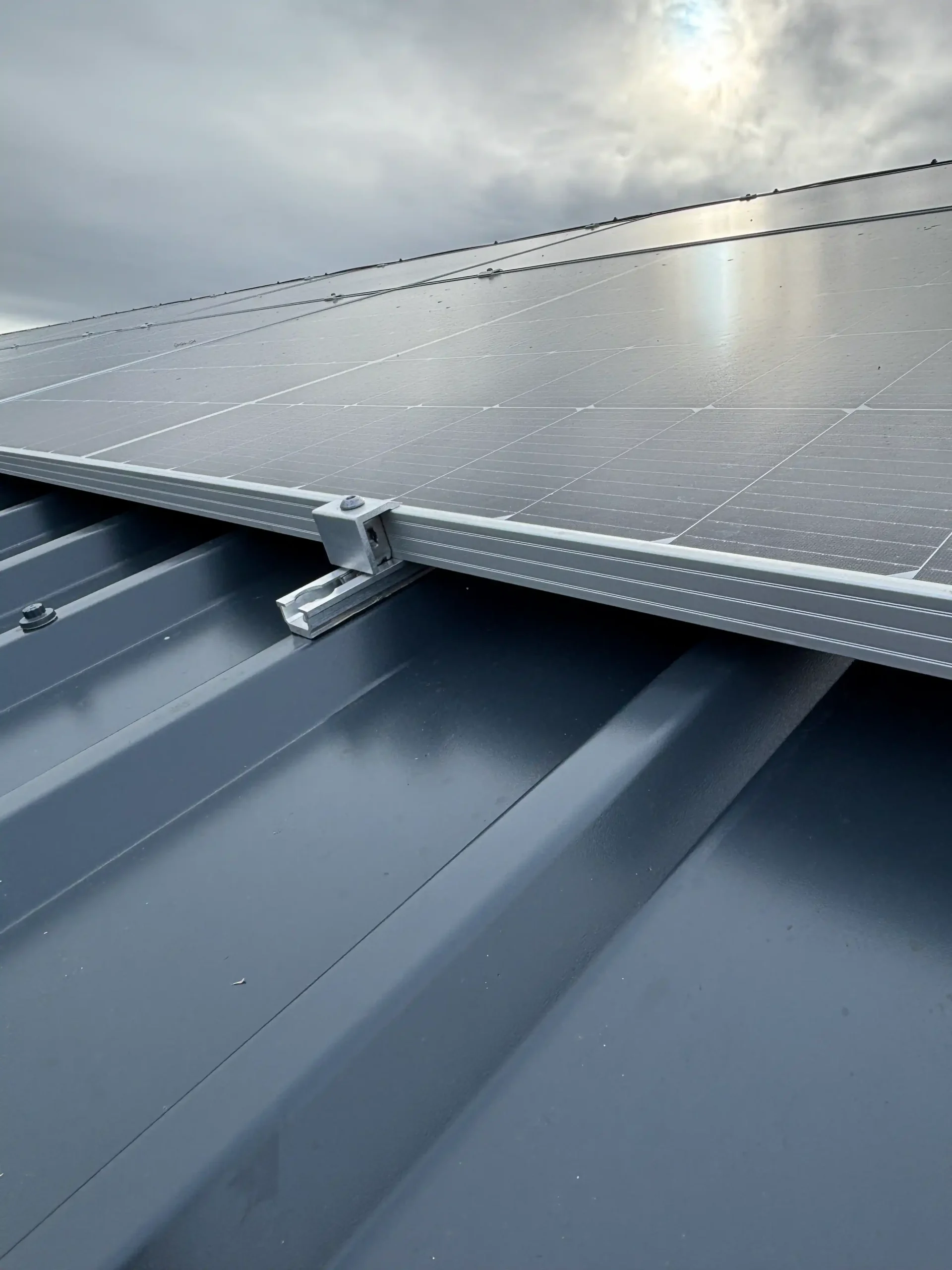 Solar panels mounted on metal roof structure with corrugated sheeting
