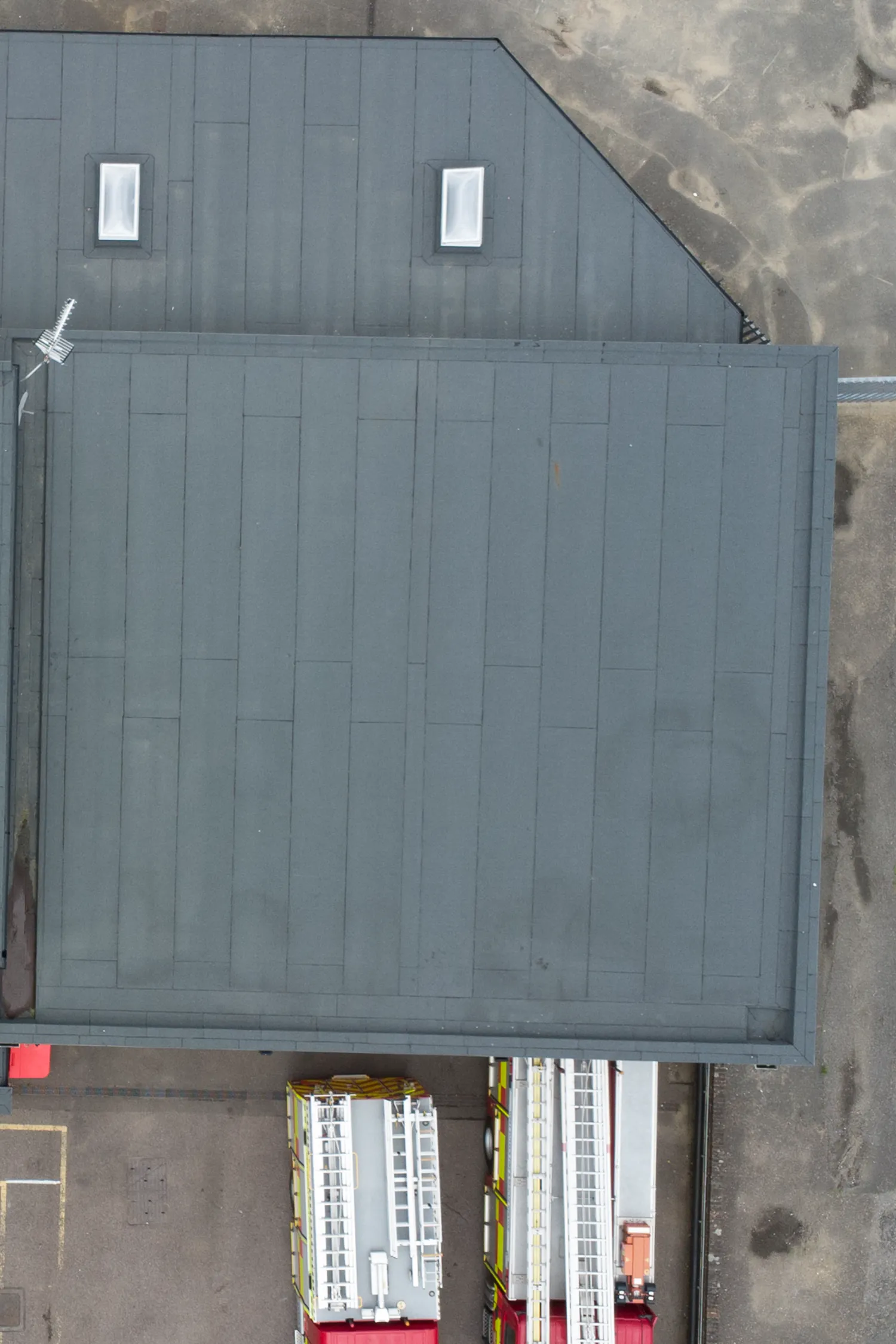 Aerial view fire station building gray metal roof two windows