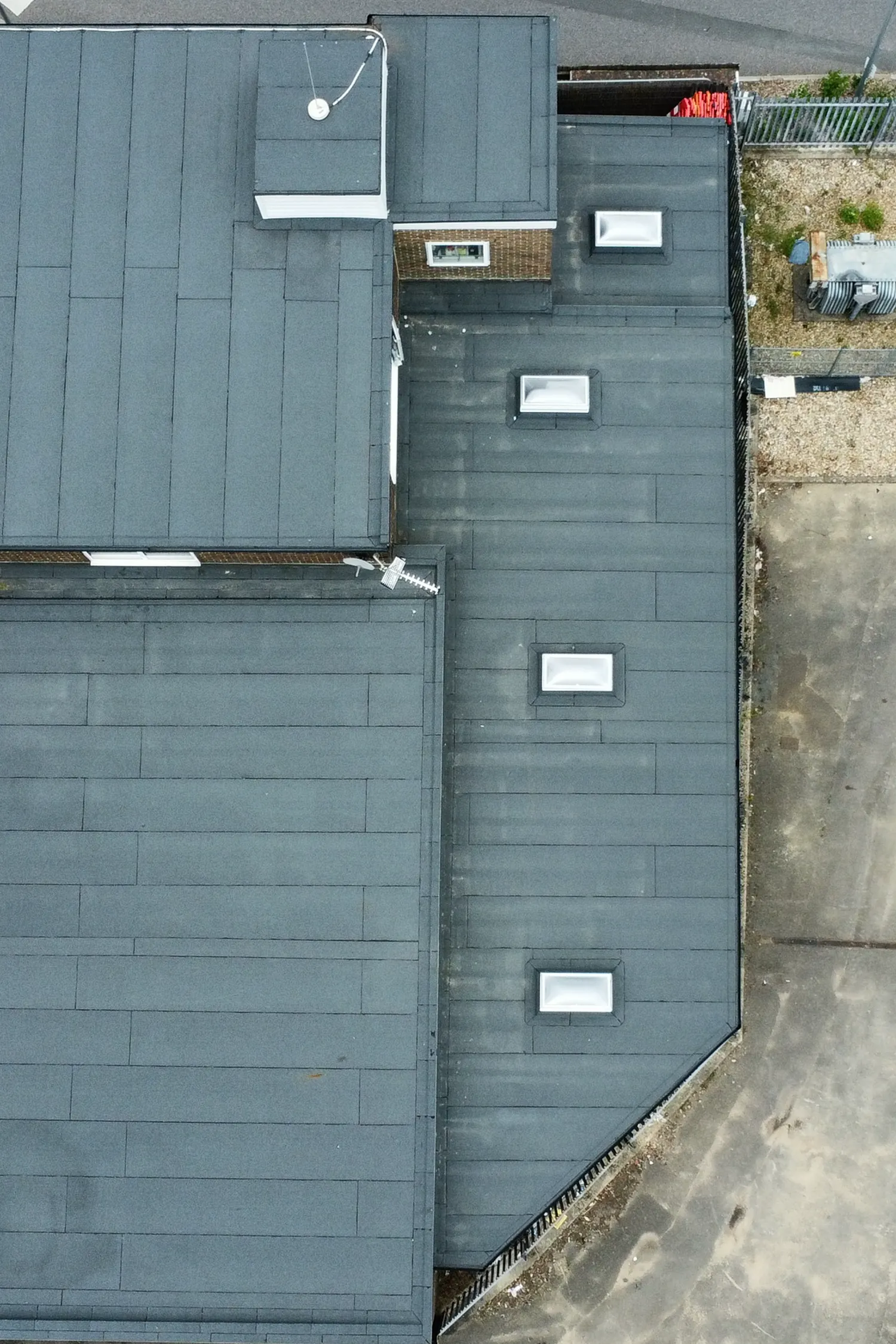 Aerial view of modern fire station roof with solar panels and skylights