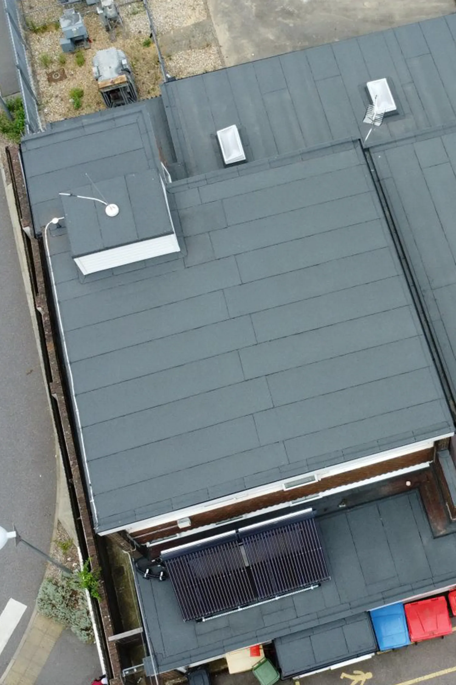 Aerial view of fire station roof with solar panels and HVAC units