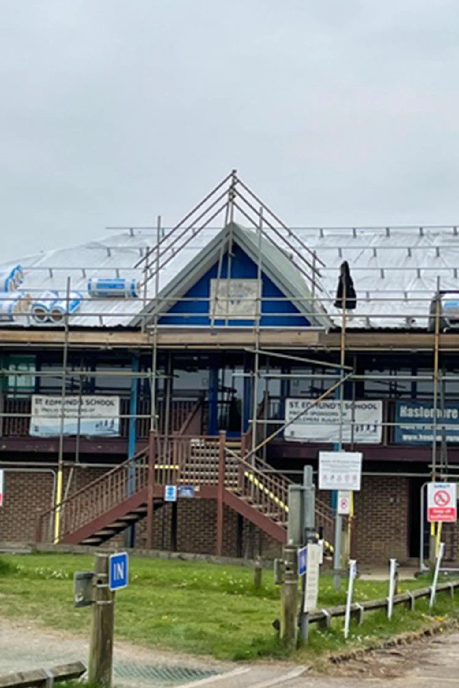 Haslemere Rugby Club building with blue roof under construction scaffolding