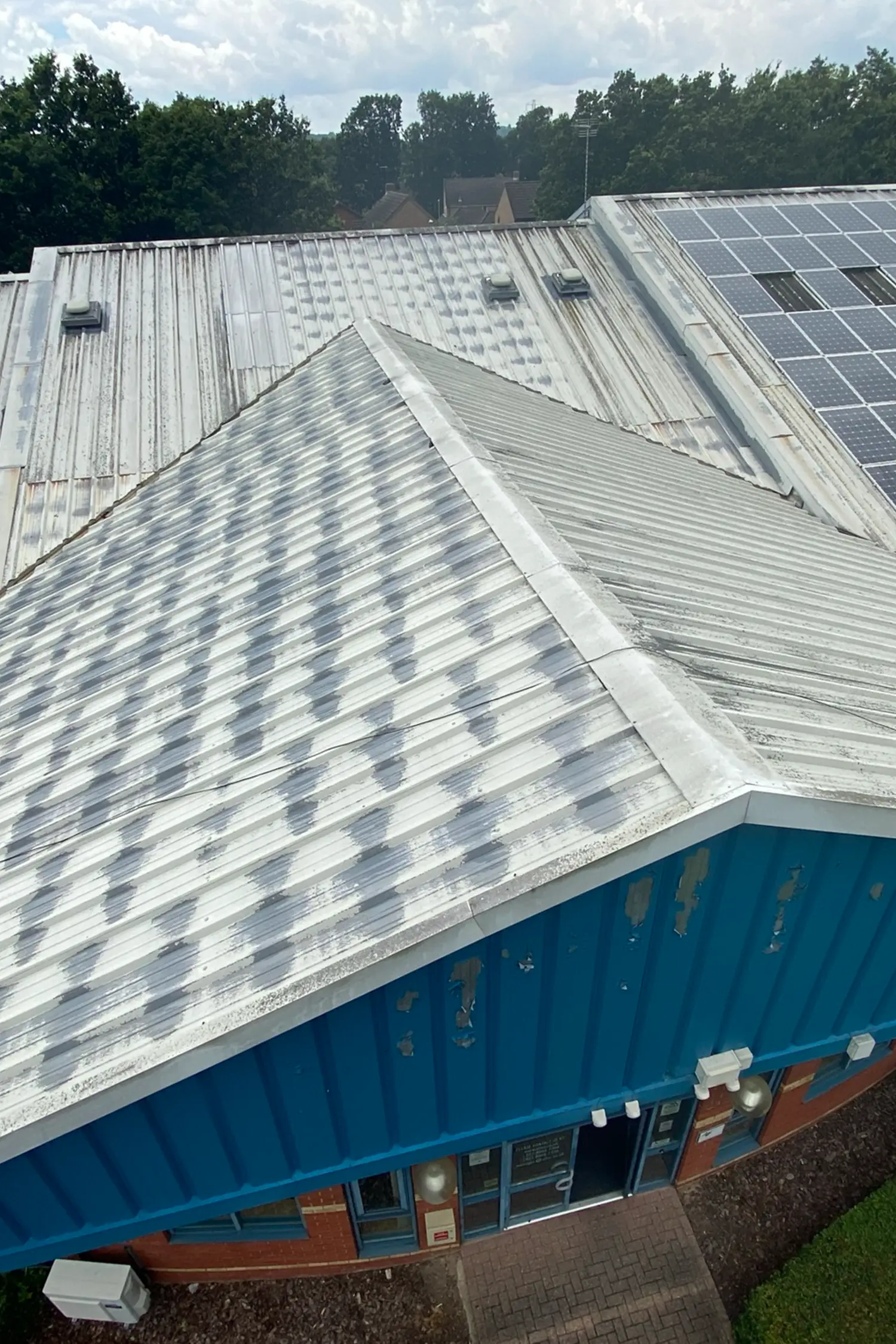 Commercial building roof with metal cladding and solar panels installed