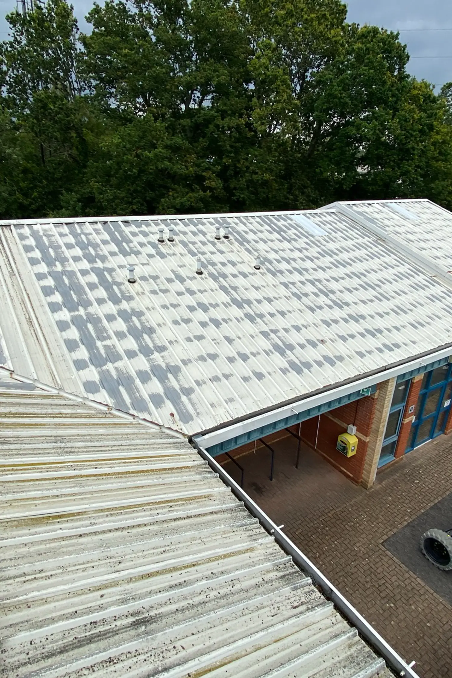 Metal roof with solar panels overlooking brick building courtyard