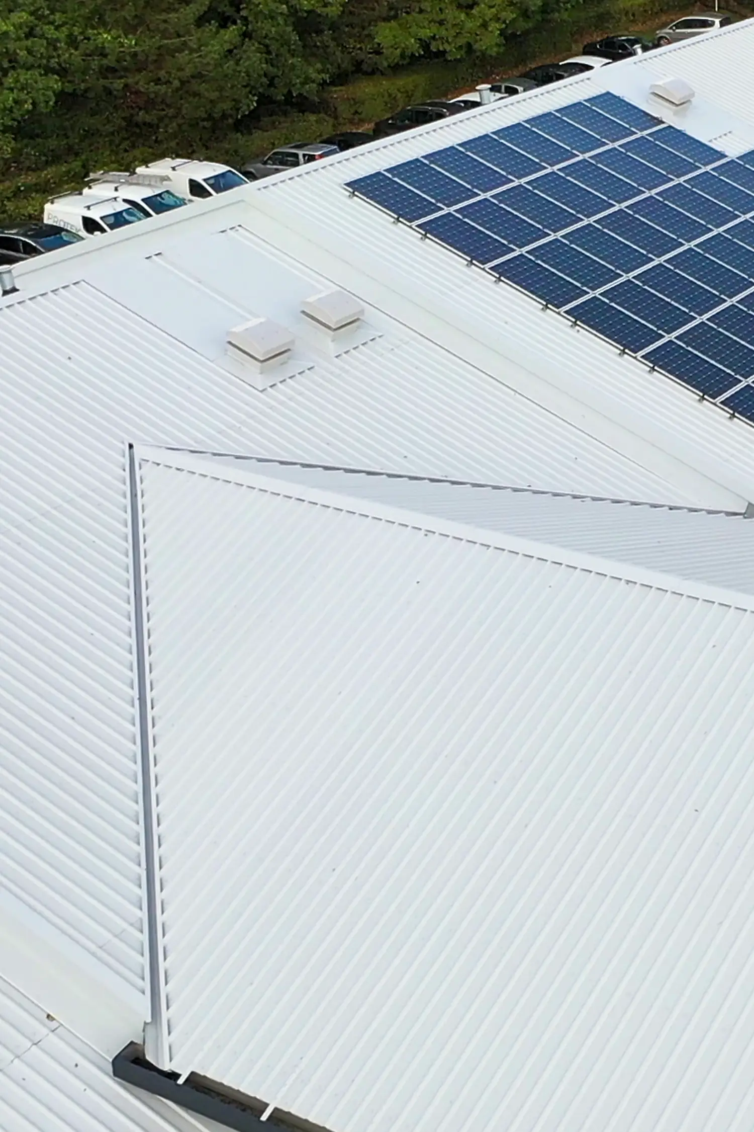 Aerial view commercial roof with solar panels and parking lot