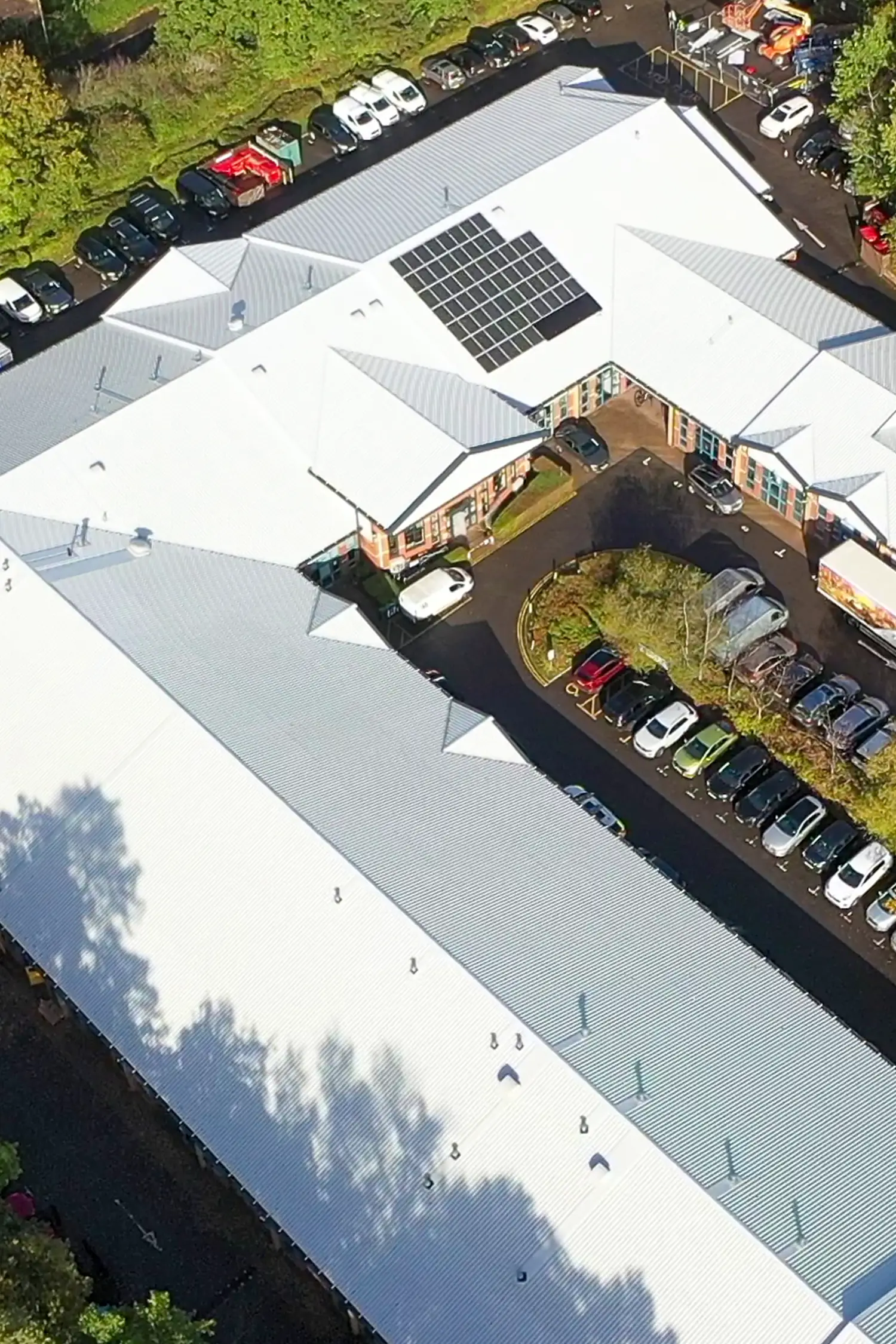 Aerial view of business enterprise centre with white metal roofing and solar panels