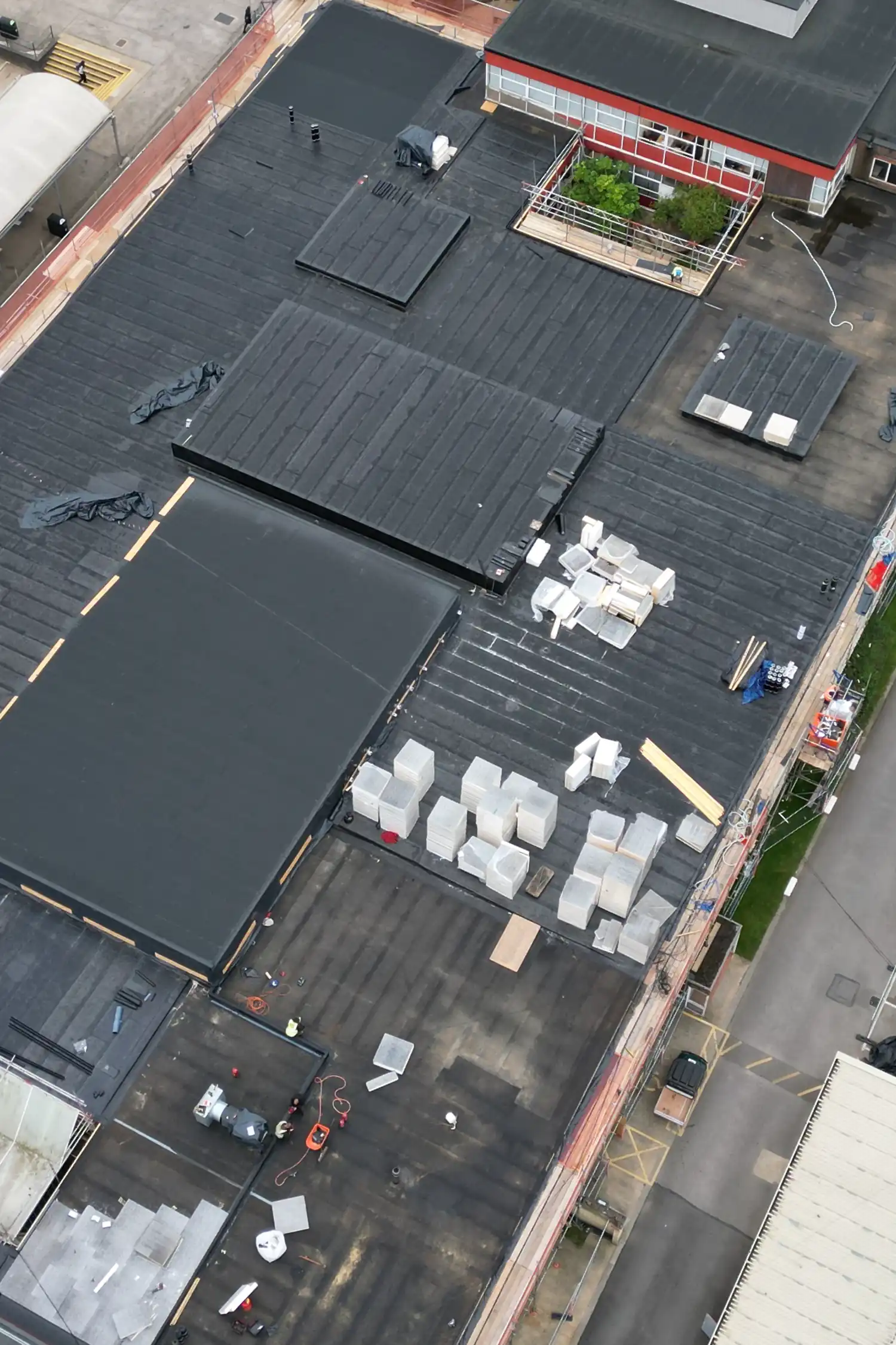 Aerial view of flat commercial rooftop with HVAC units and equipment