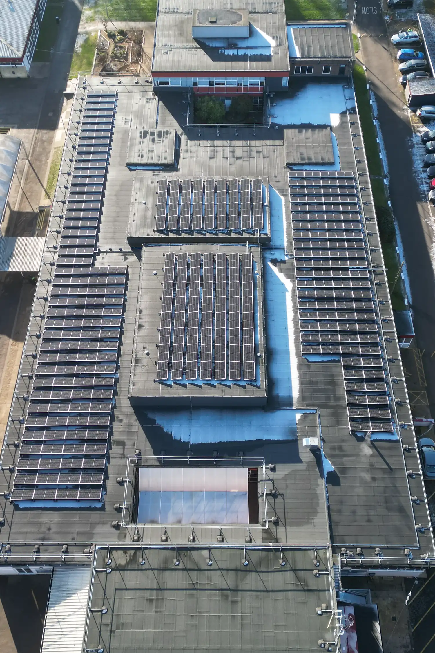Aerial view of school rooftop with extensive solar panel arrays installed