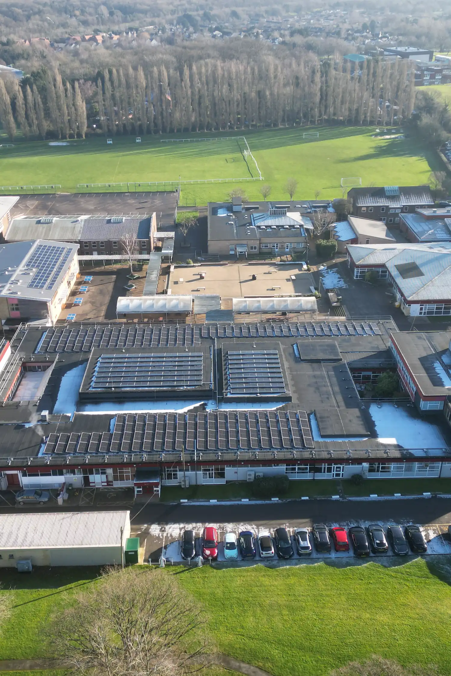 Aerial view school building with extensive rooftop solar panels installation