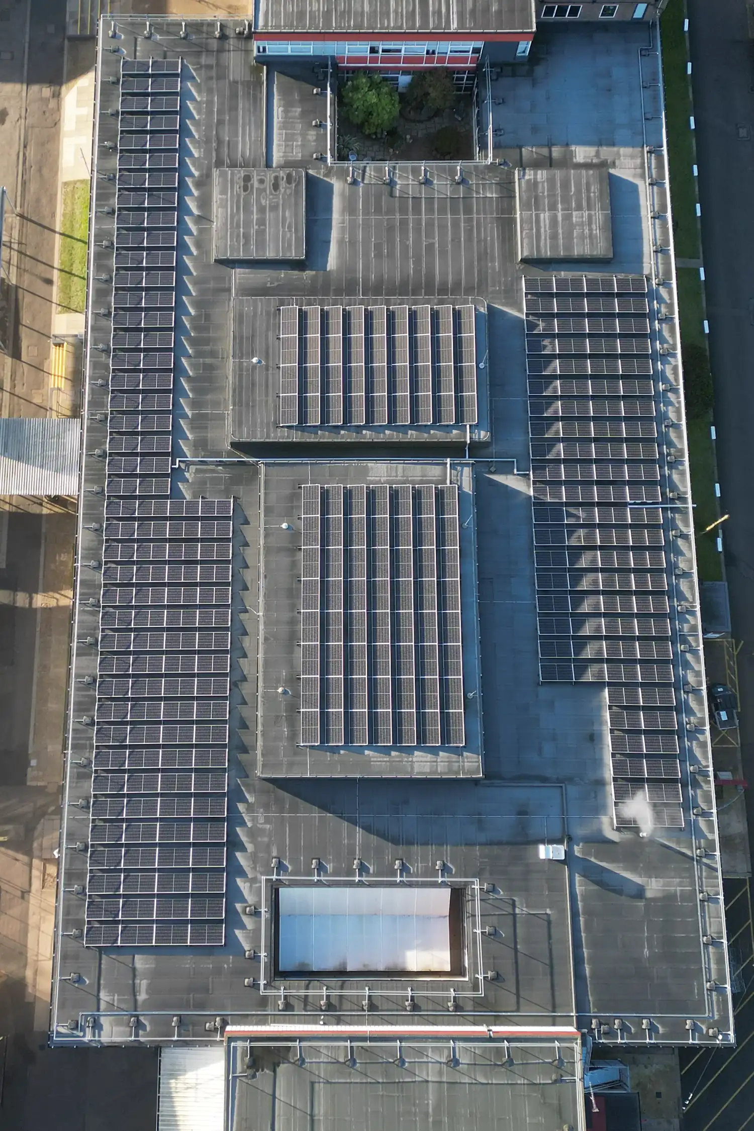 Aerial view of school rooftop with extensive solar panel installation arrays