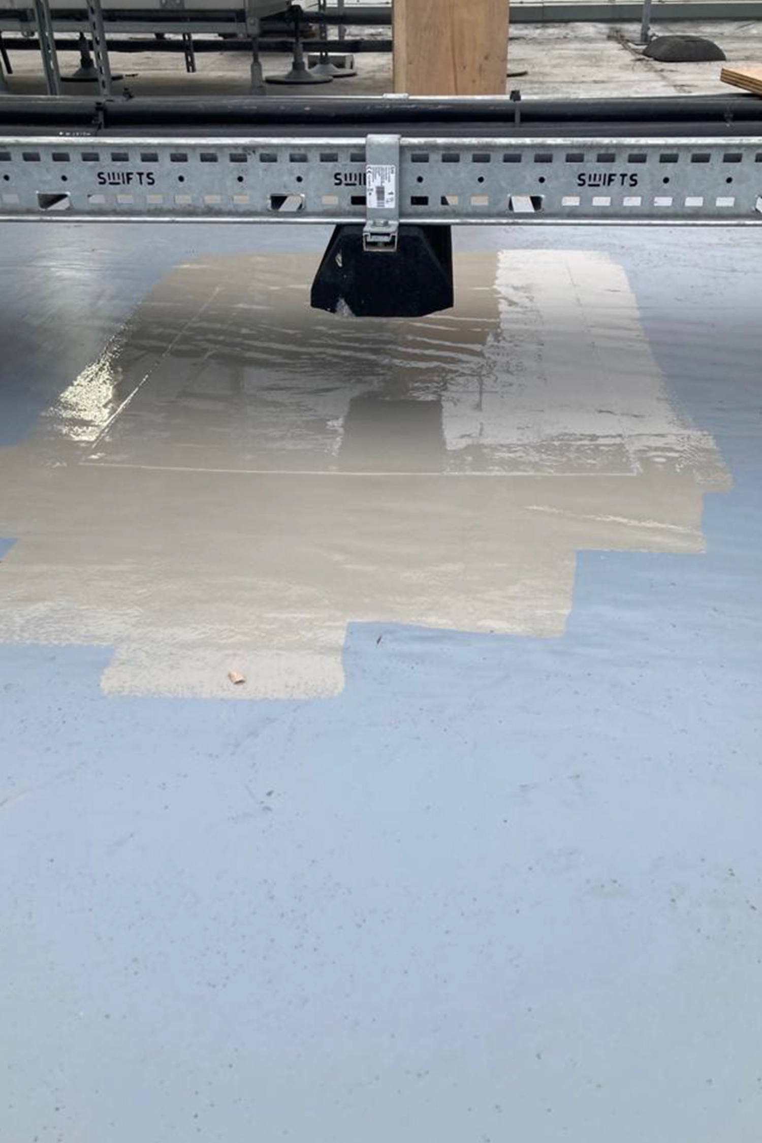 Flat roof waterproofing membrane installation with ponding water and metal flashing detail.