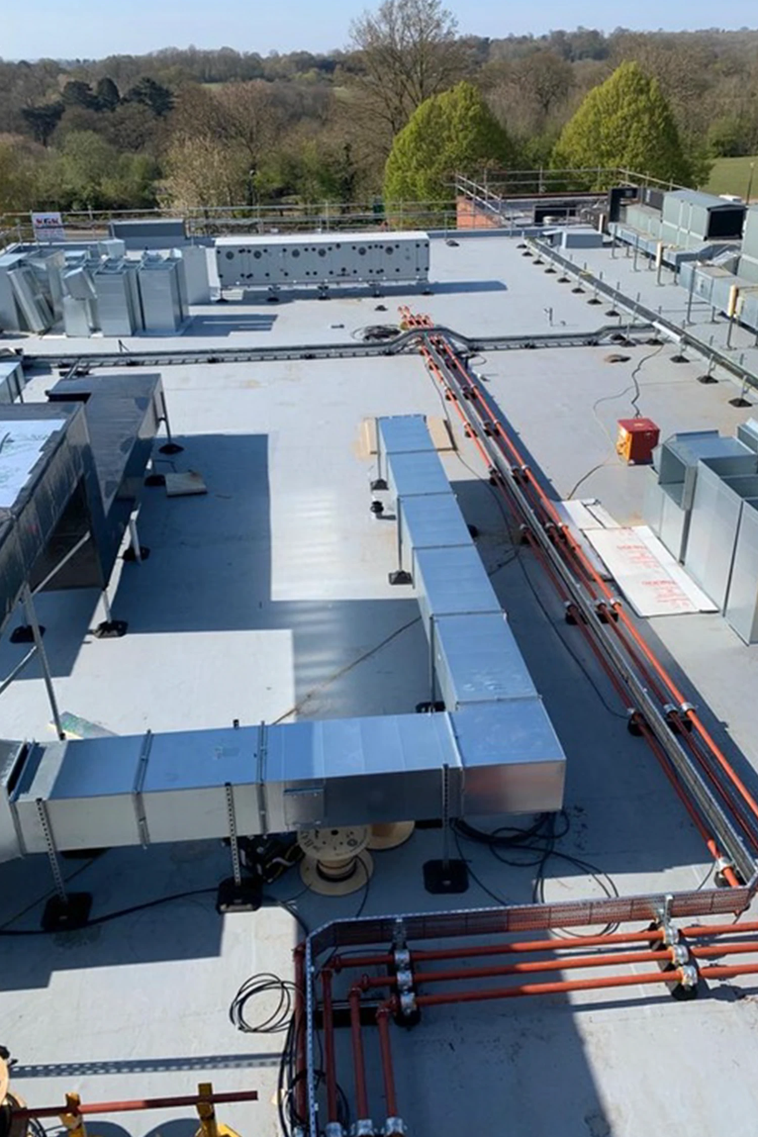 Commercial rooftop with blue solar panels and waterproofing installation system