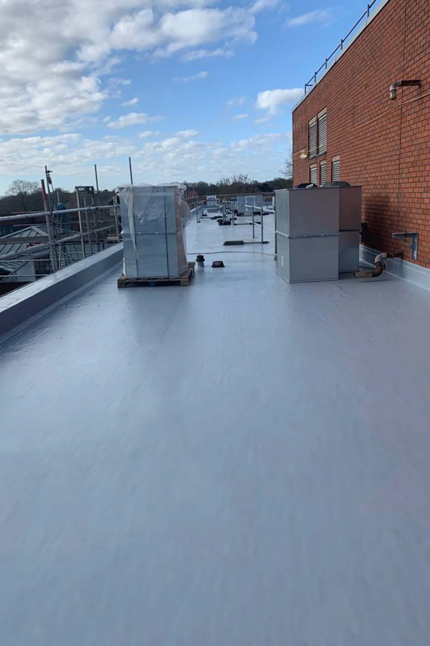 Flat roof waterproofing installation at Queen Mary's Hospital with HVAC units
