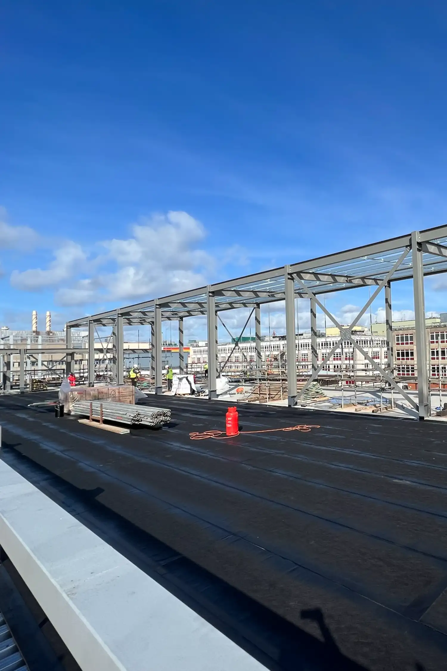 Rooftop construction site with steel framework and black membrane waterproofing Southampton General Hospital
