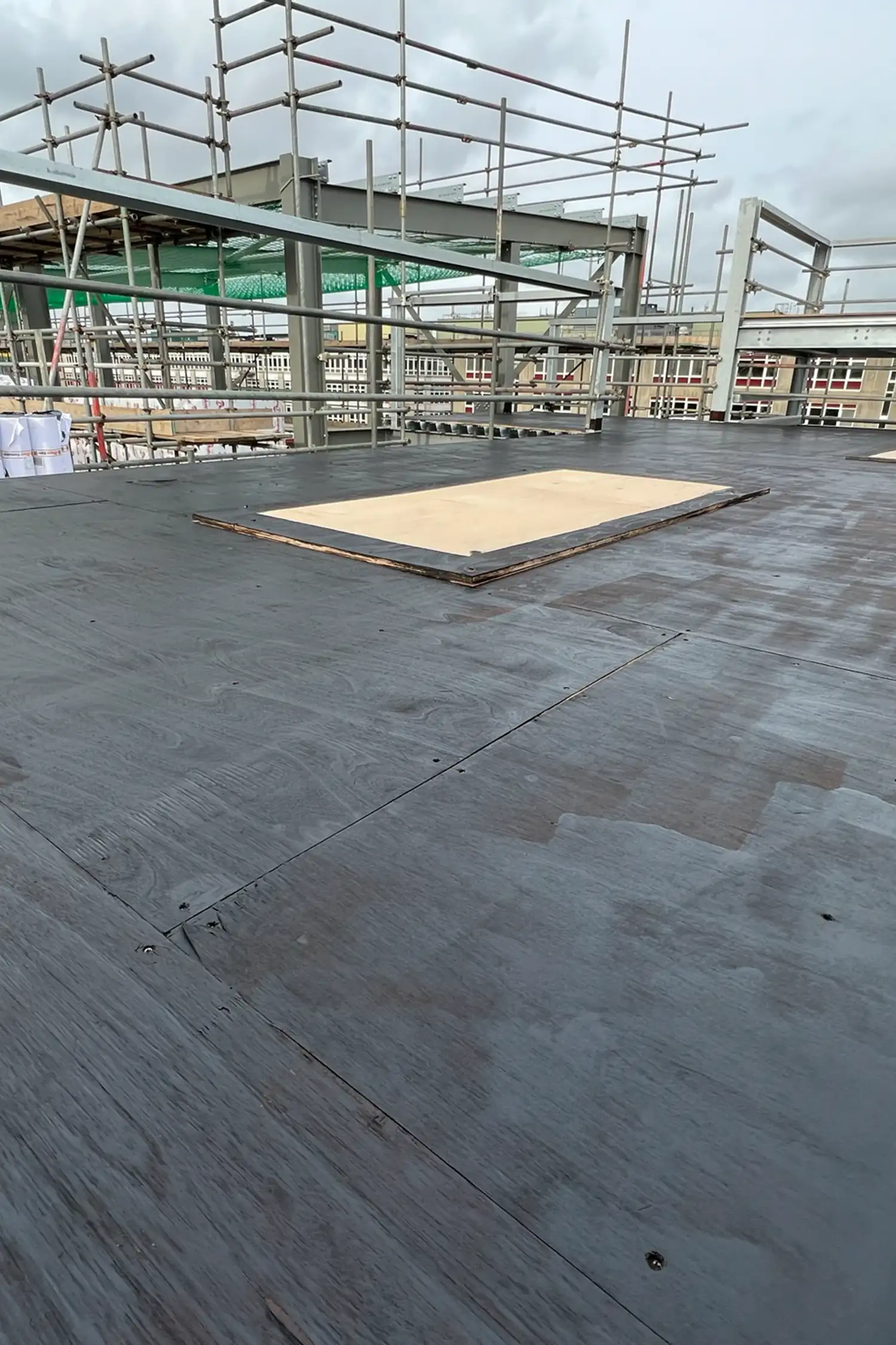 Construction site with steel framework and plywood flooring at Southampton General Hospital extension