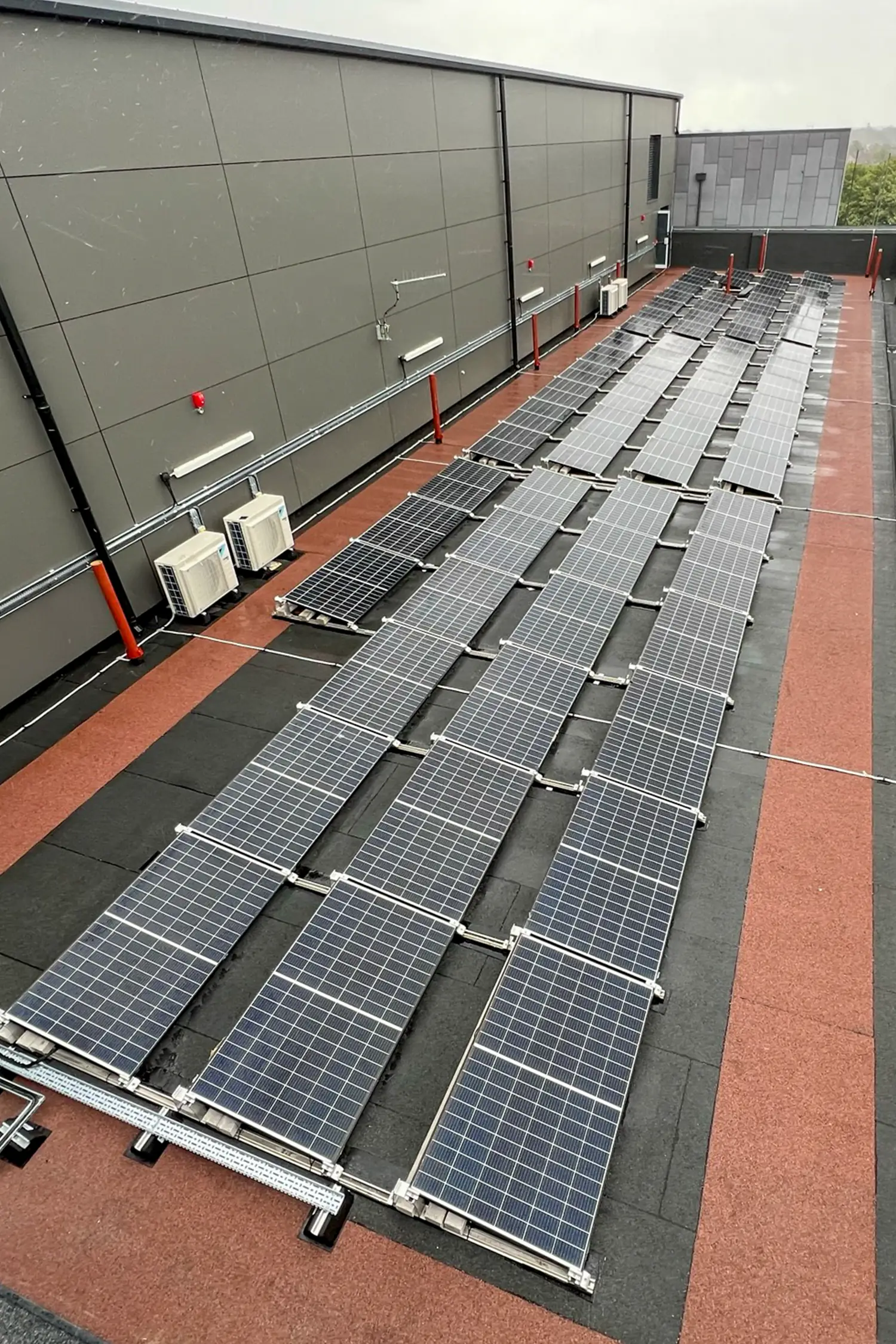 Rooftop solar panel array installation on hospital building extension