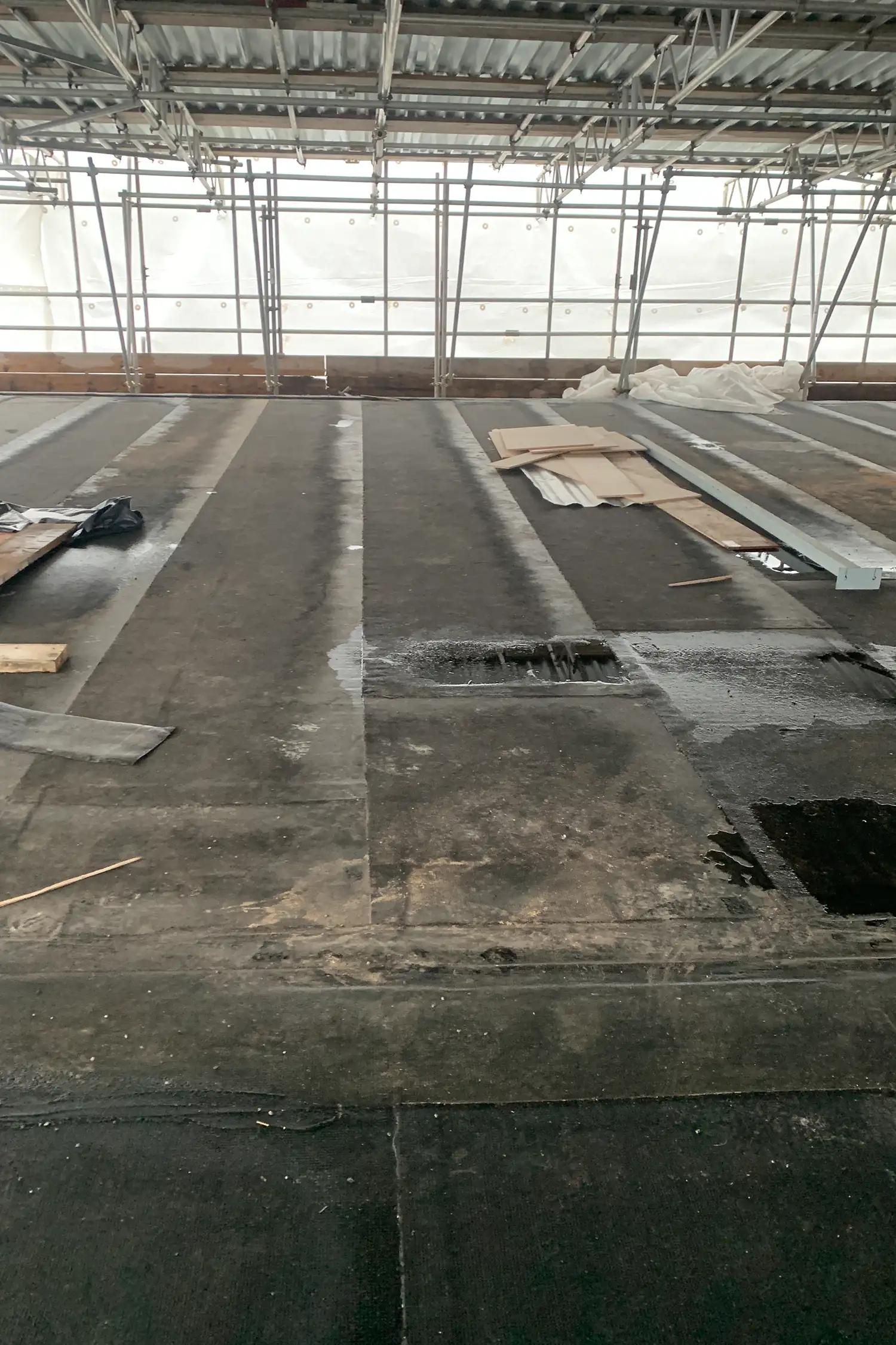 Industrial warehouse interior with concrete floor and metal roof structure