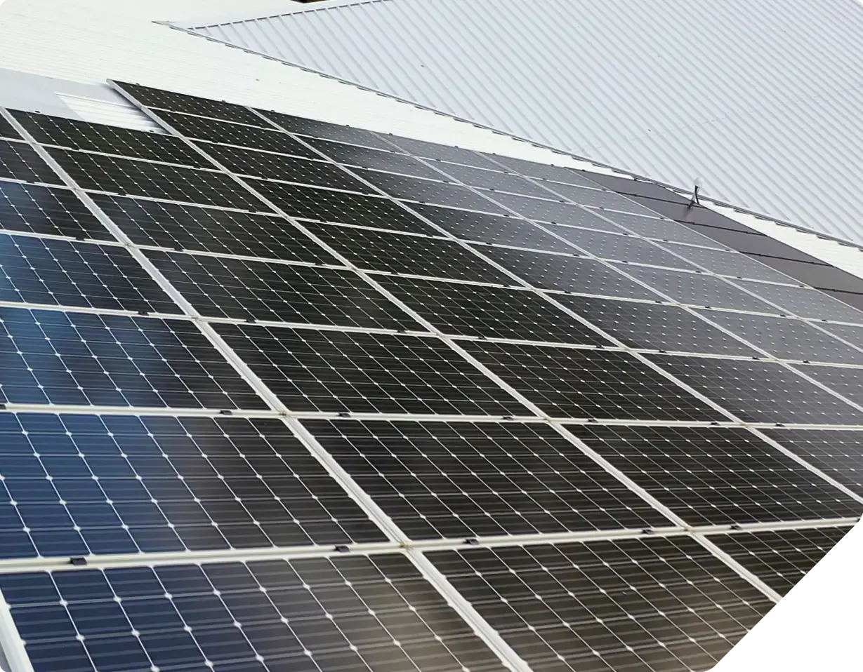 Solar panels installed on metal roof of commercial building structure