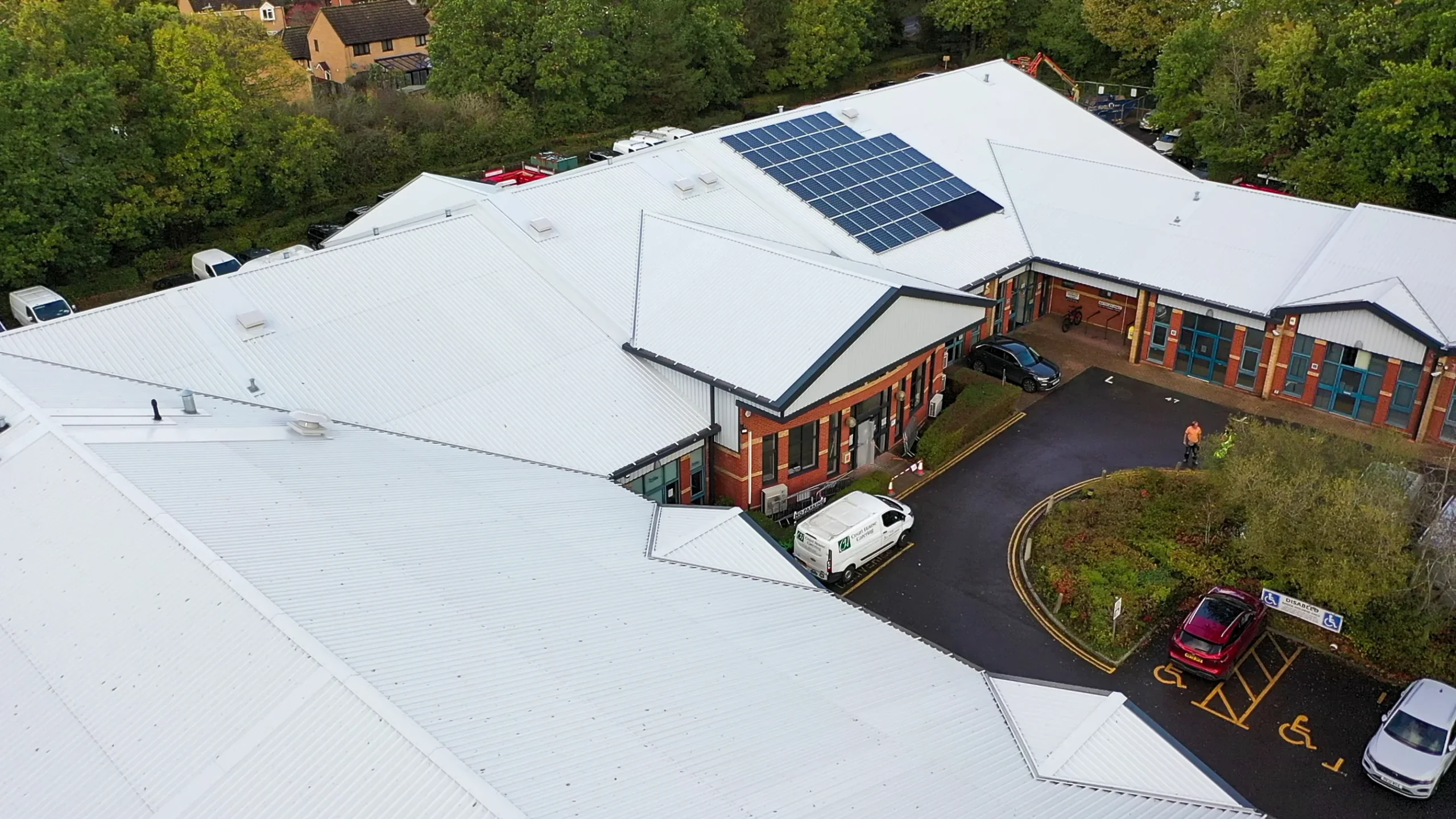 Aerial view of New Forest Enterprise Centre with white roof and solar panels