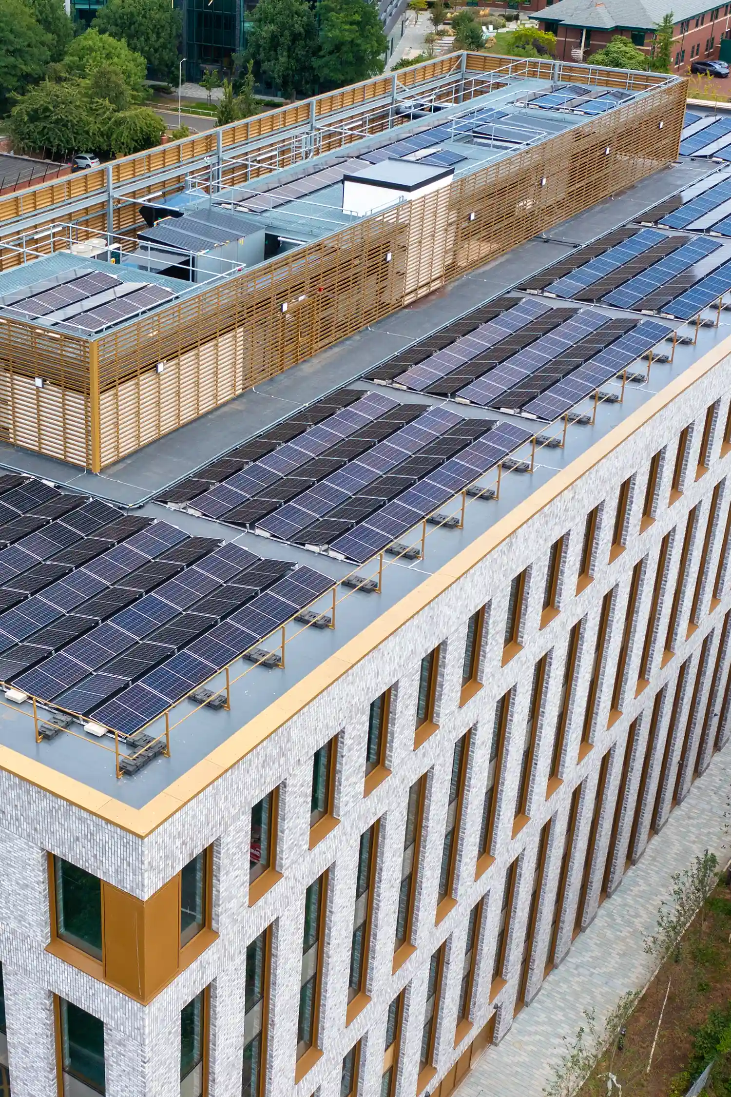 Rooftop solar panels on modern commercial office building with wooden screening