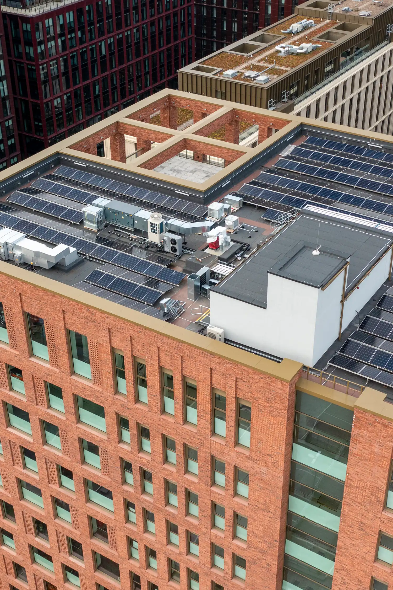 Urban rooftop with solar panels and HVAC equipment on commercial building