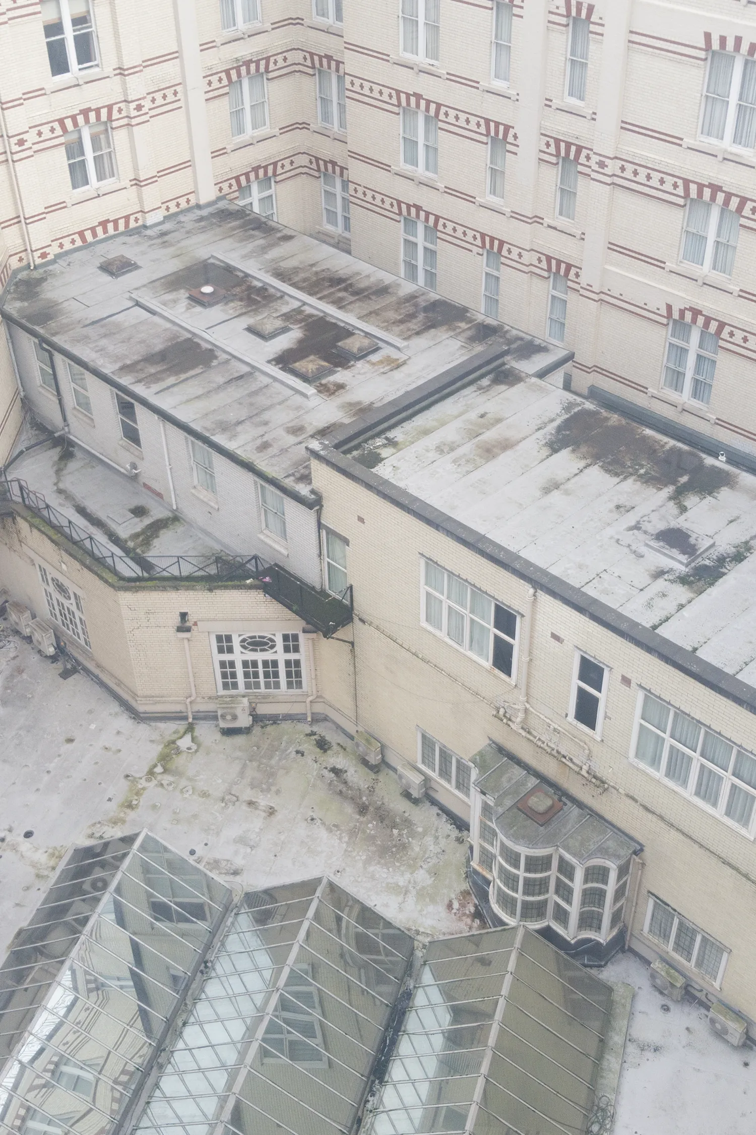Aerial view of Midland Hotel courtyard with deteriorating rooftops and surrounding buildings