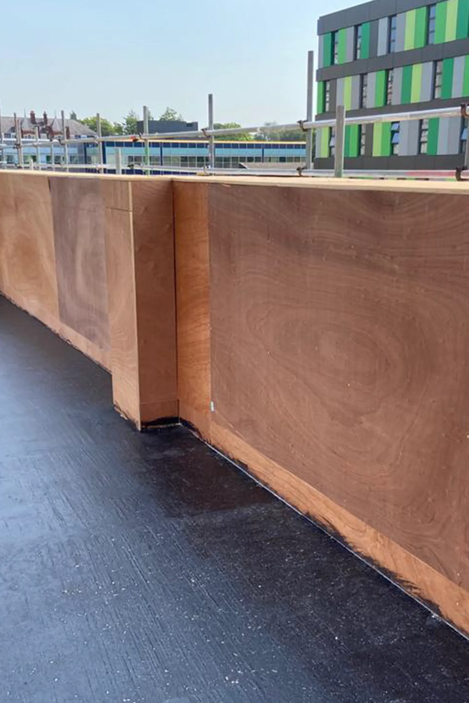 Modern rooftop terrace with copper-colored walls and dark flooring at hospital
